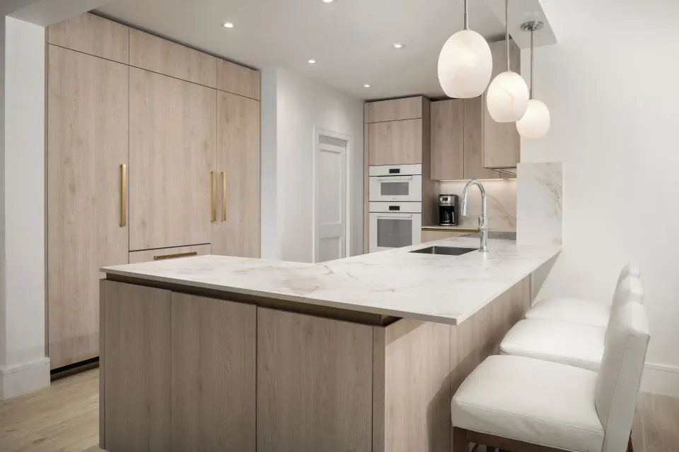 Oceanfront three-bedroom luxury suite kitchen with island seating at Point Grace.