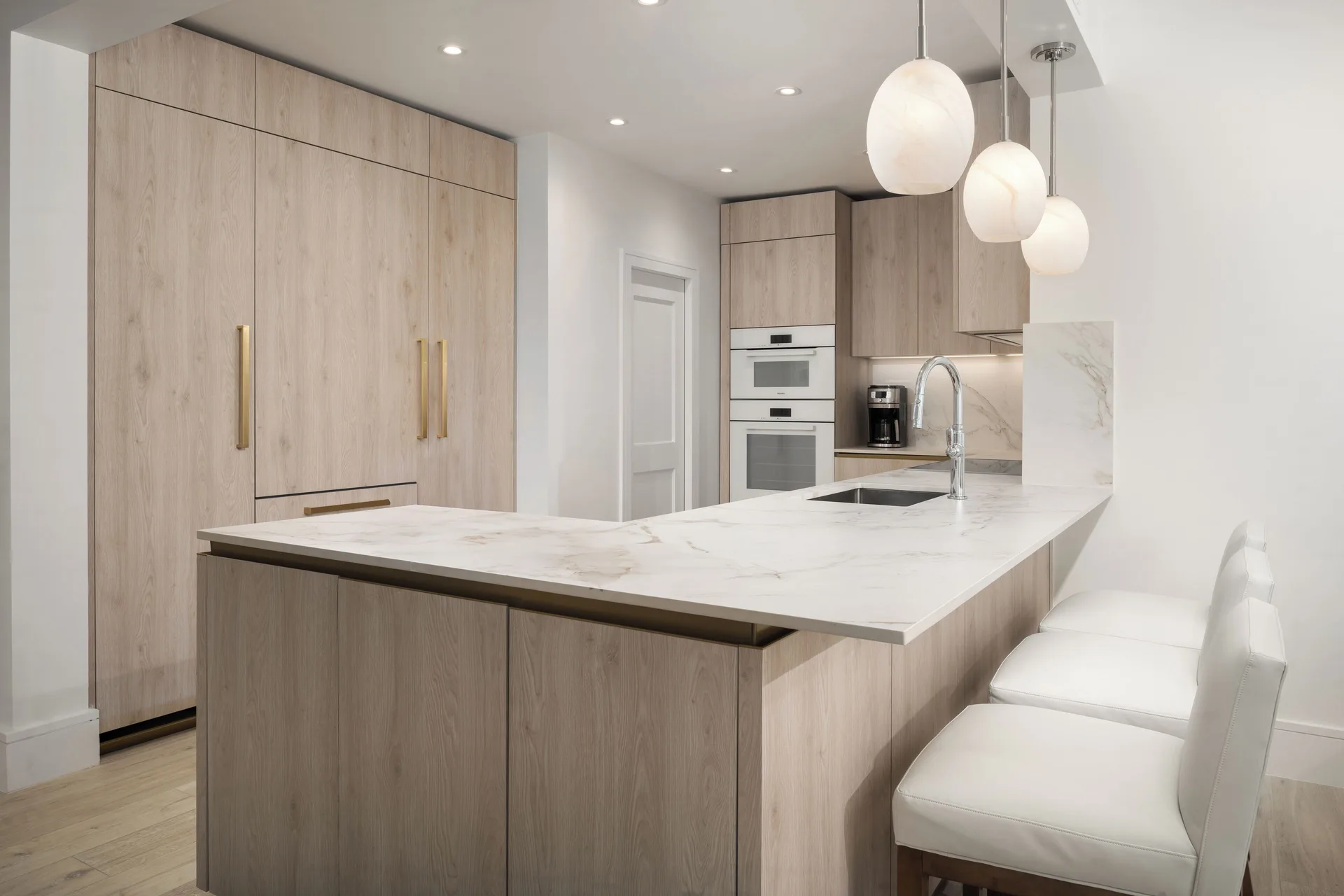 Oceanfront three-bedroom luxury suite kitchen with island seating at Point Grace.