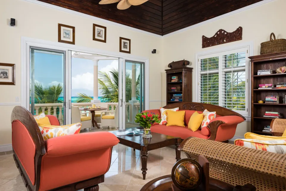 Oceanfront three-bedroom luxury suite living room and balcony view at Point Grace.