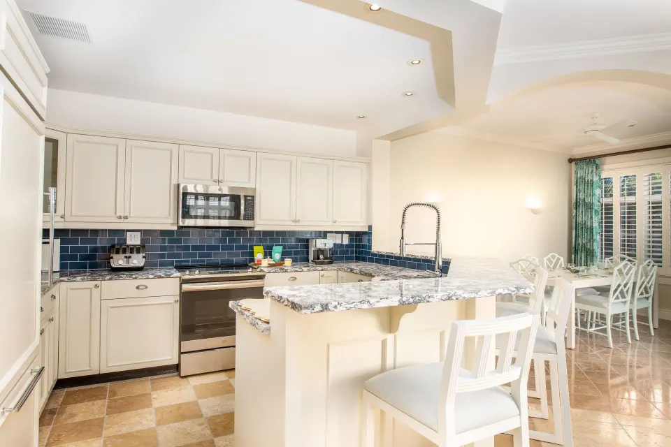 Kitchen with breakfast bar in a Pool View Cottage 1 Bedroom Suite at Point Grace.