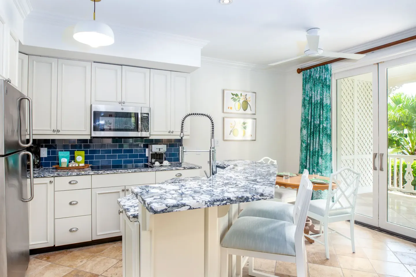 Kitchen and dining area in a Pool View Cottage 1 Bedroom Suite at Point Grace.