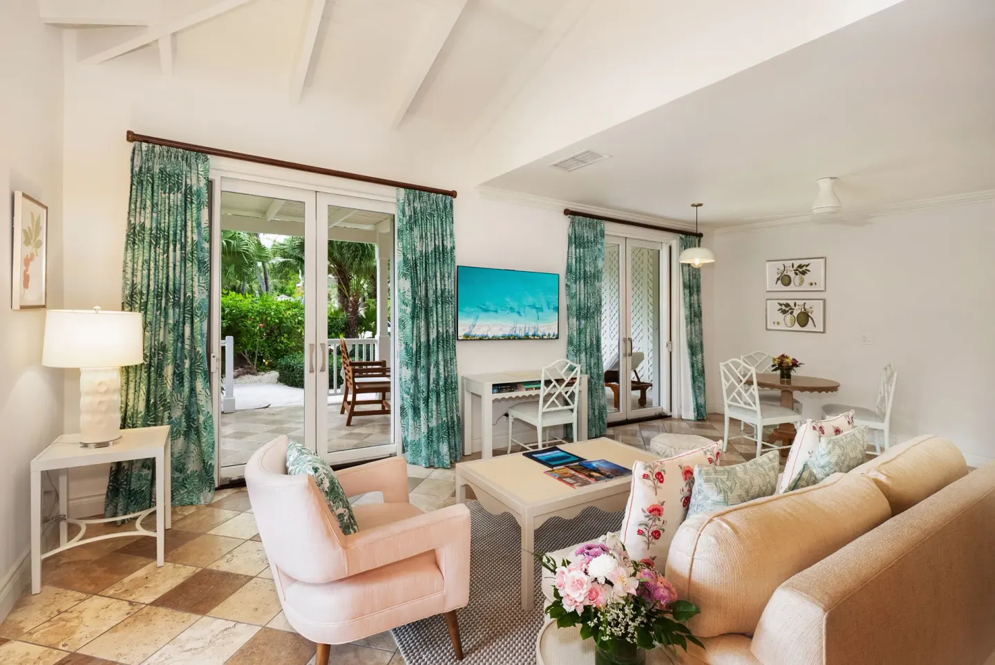 Living area with patio doors in a Pool View Cottage 1 Bedroom Suite at Point Grace.