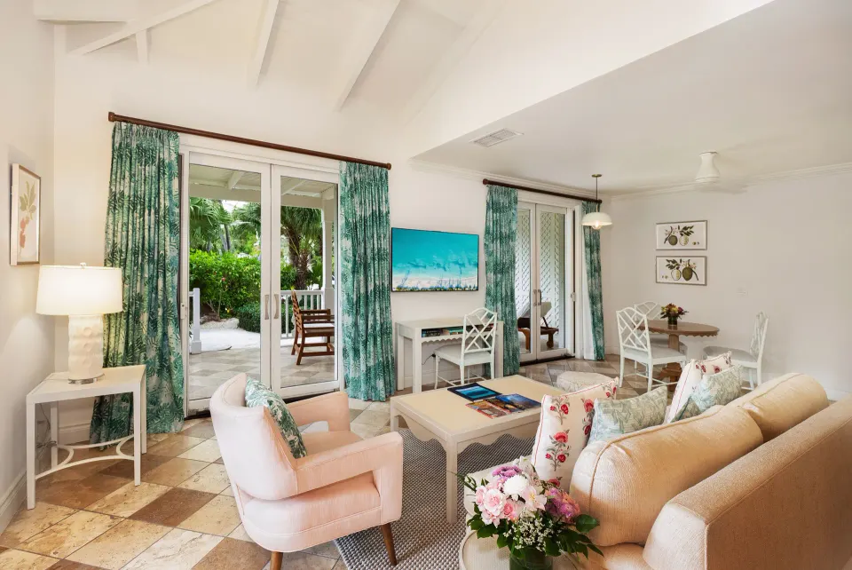 Living area with patio doors in a Pool View Cottage 1 Bedroom Suite at Point Grace.