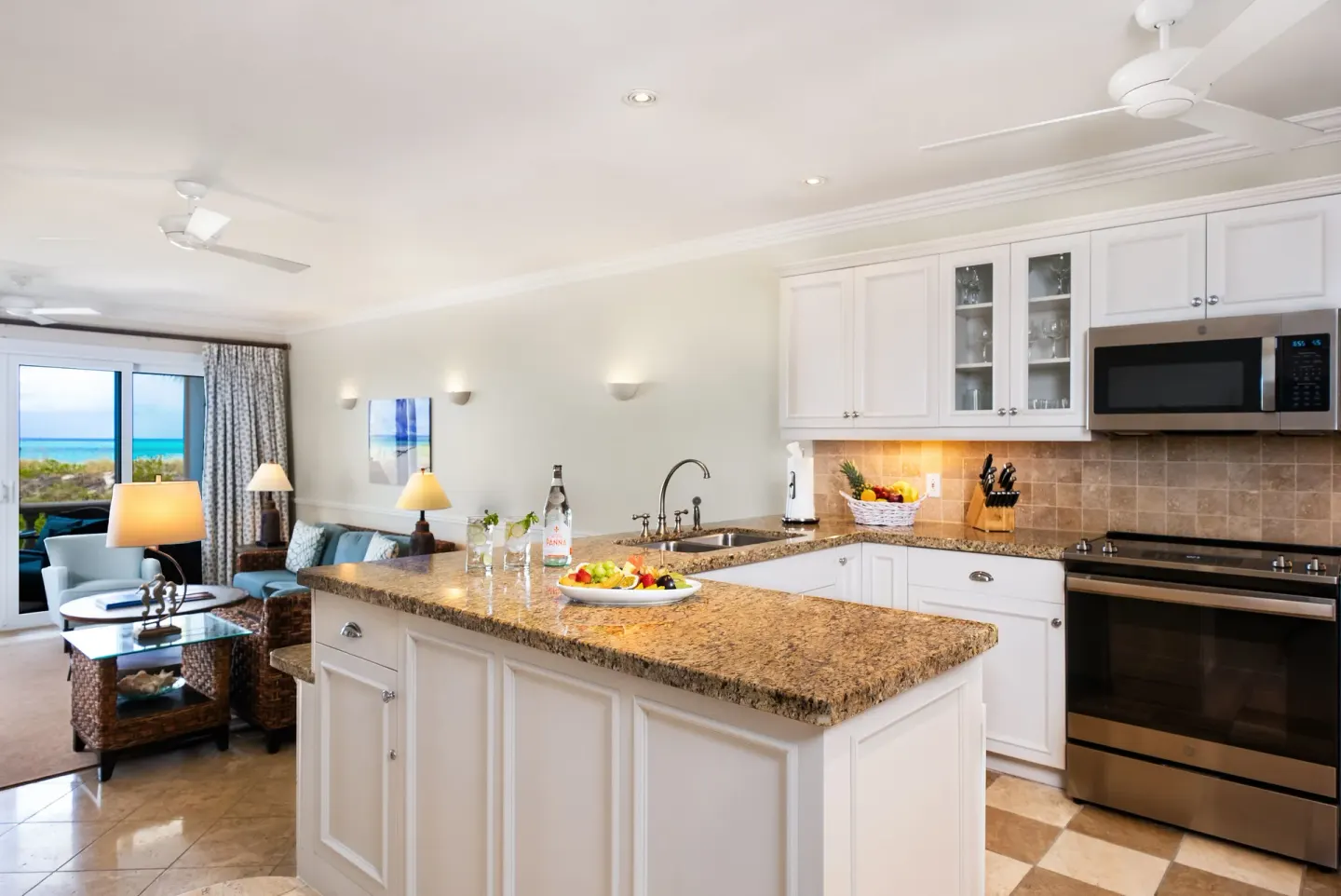 Open kitchen and sitting room in a Pool View Cottage 1 Bedroom Suite at Point Grace.