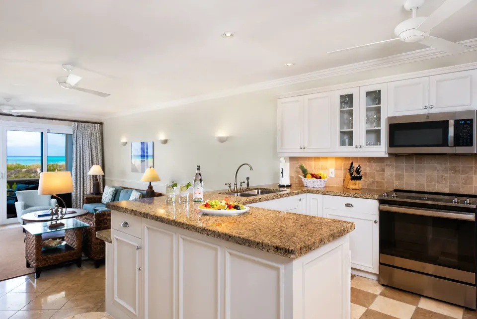 Open kitchen and sitting room in a Pool View Cottage 1 Bedroom Suite at Point Grace.