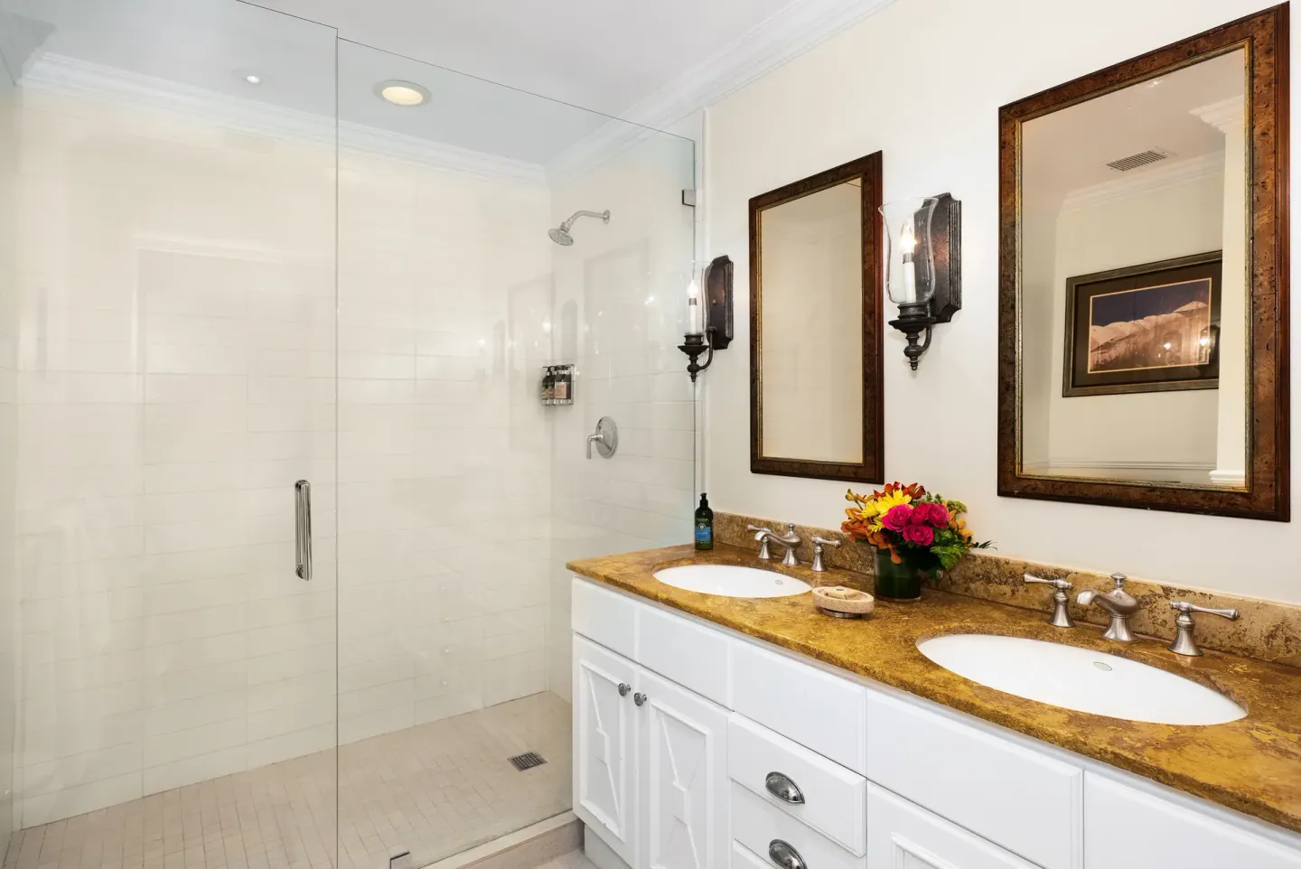 Oceanfront one-bedroom suite bathroom with glass shower and double sinks at Point Grace.