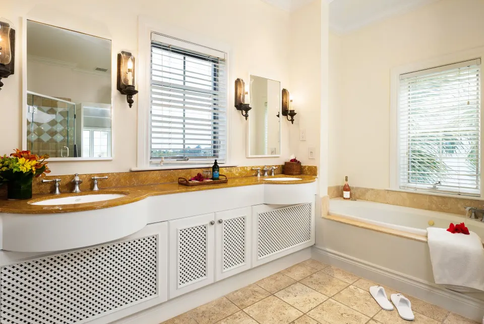 Oceanfront one-bedroom suite bathroom with double vanity and tub at Point Grace.