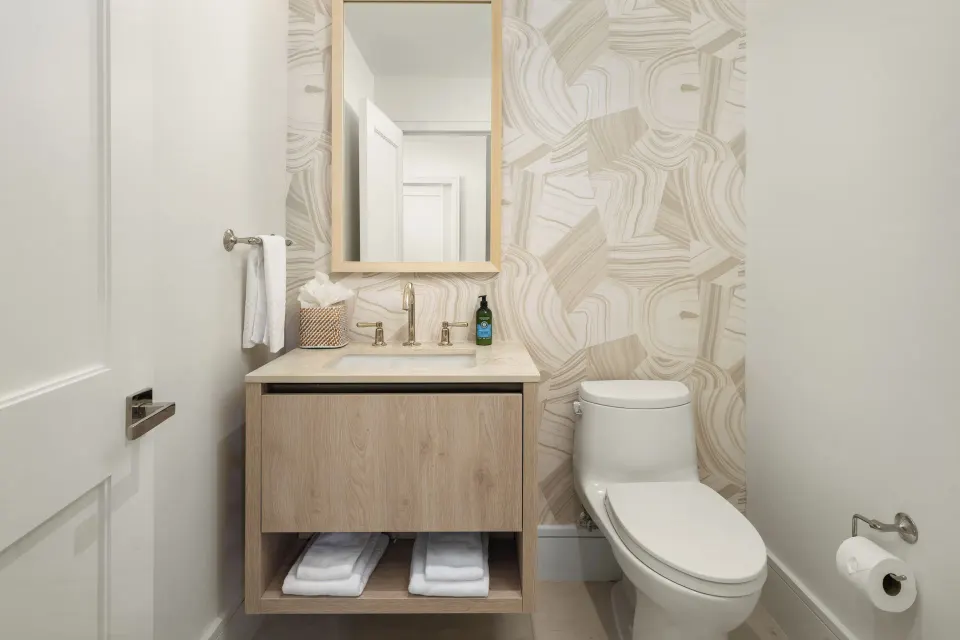 Oceanfront one-bedroom suite powder room with vanity and patterned wall at Point Grace.