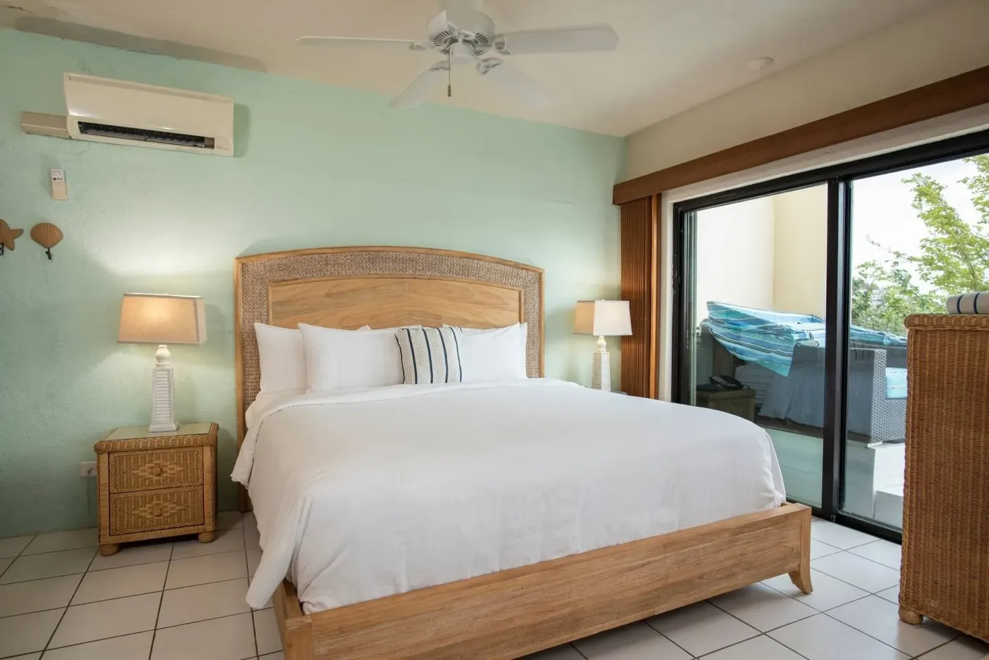 Guest room with king bed and sliding glass doors at Point Pleasant Resort.