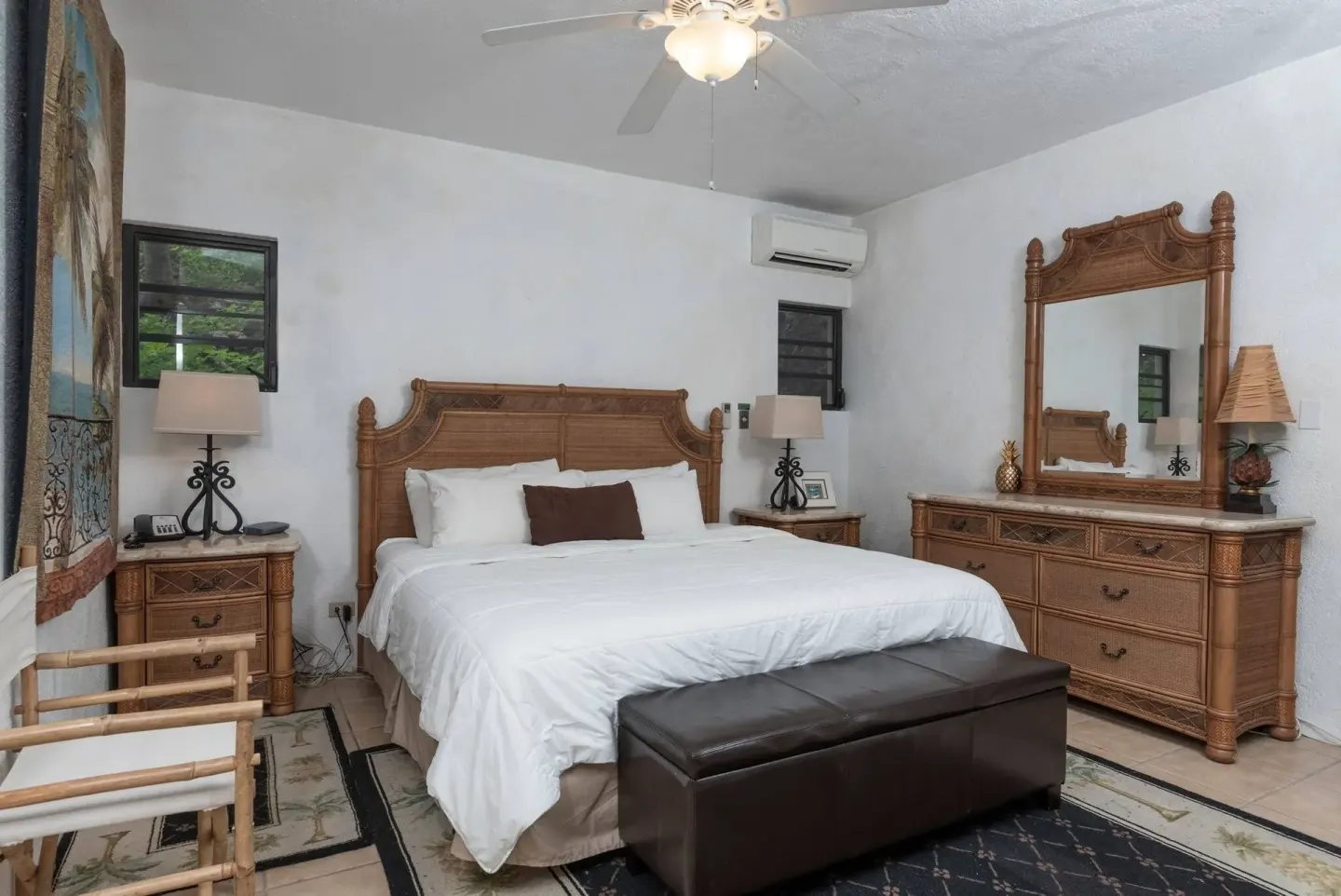 Guest room with king bed, dresser and carved wood furniture at Point Pleasant Resort.