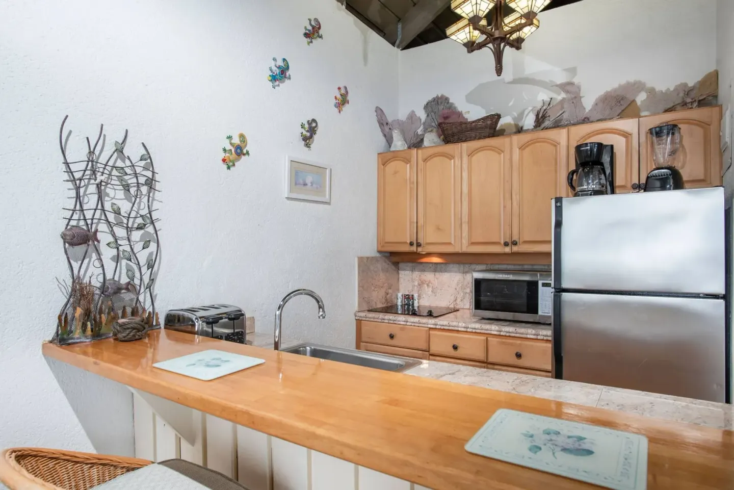 Kitchenette counter with sink, toaster and refrigerator at Point Pleasant Resort.
