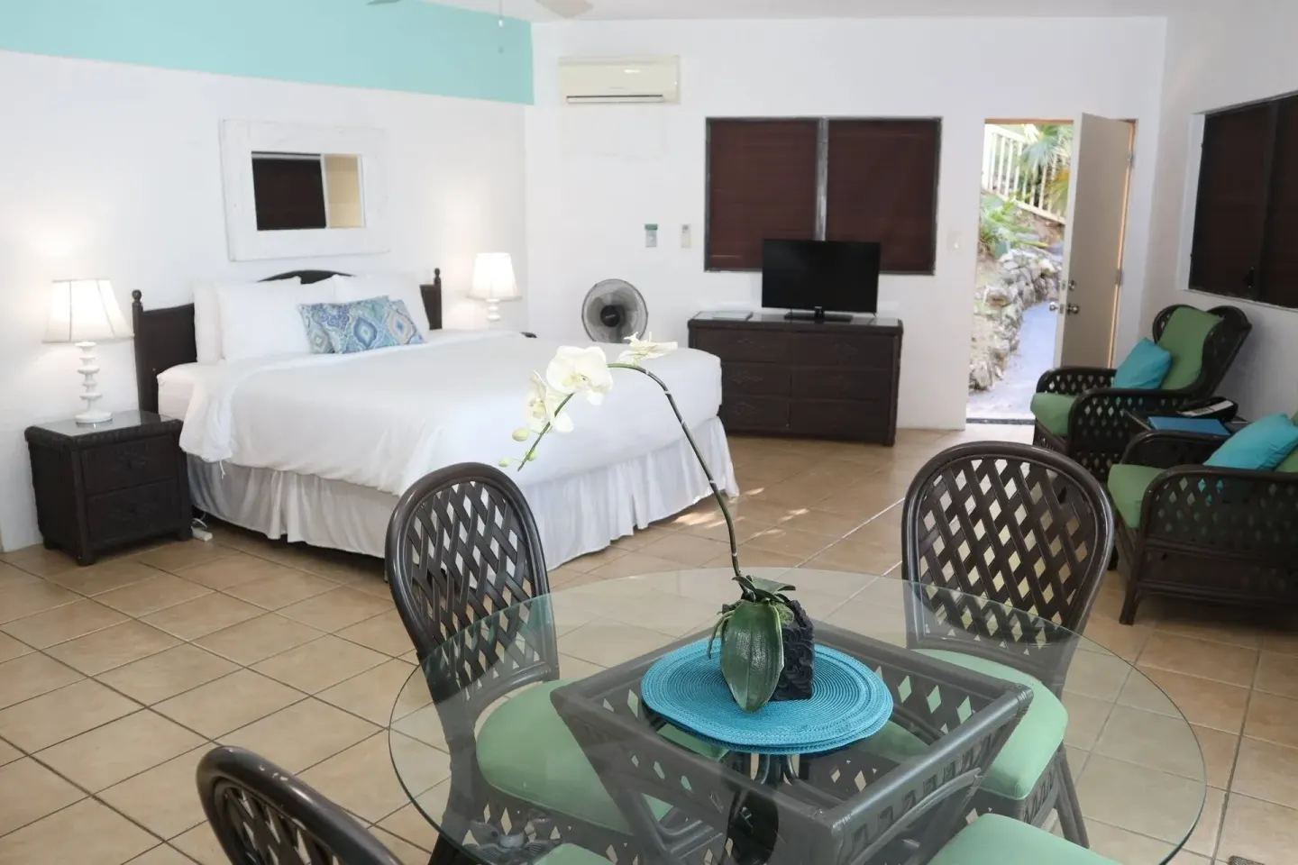 Studio guest room with bed, dining table and seating at Point Pleasant Resort.