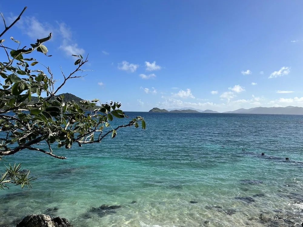 Clear turquoise shoreline at Point Pleasant Resort with islands visible beyond the water.