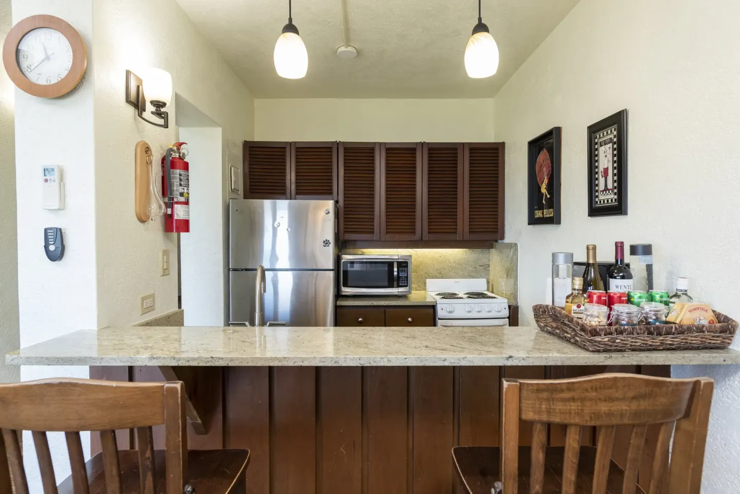 Compact condo kitchen with breakfast bar and stools at Point Pleasant Resort.