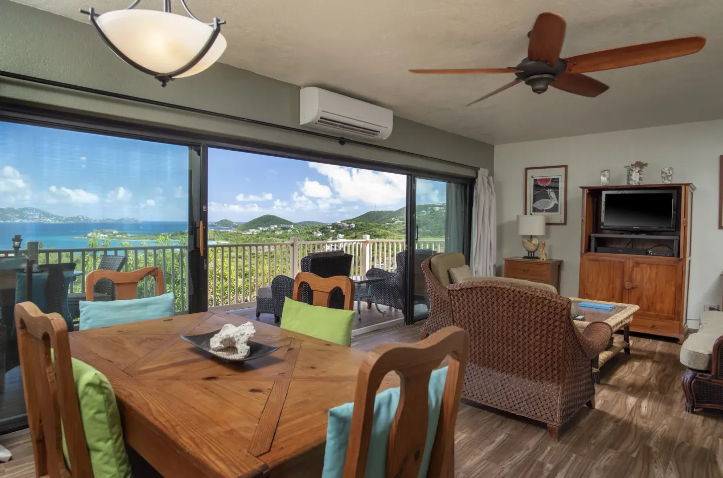 Condo living and dining area with balcony water view at Point Pleasant Resort.