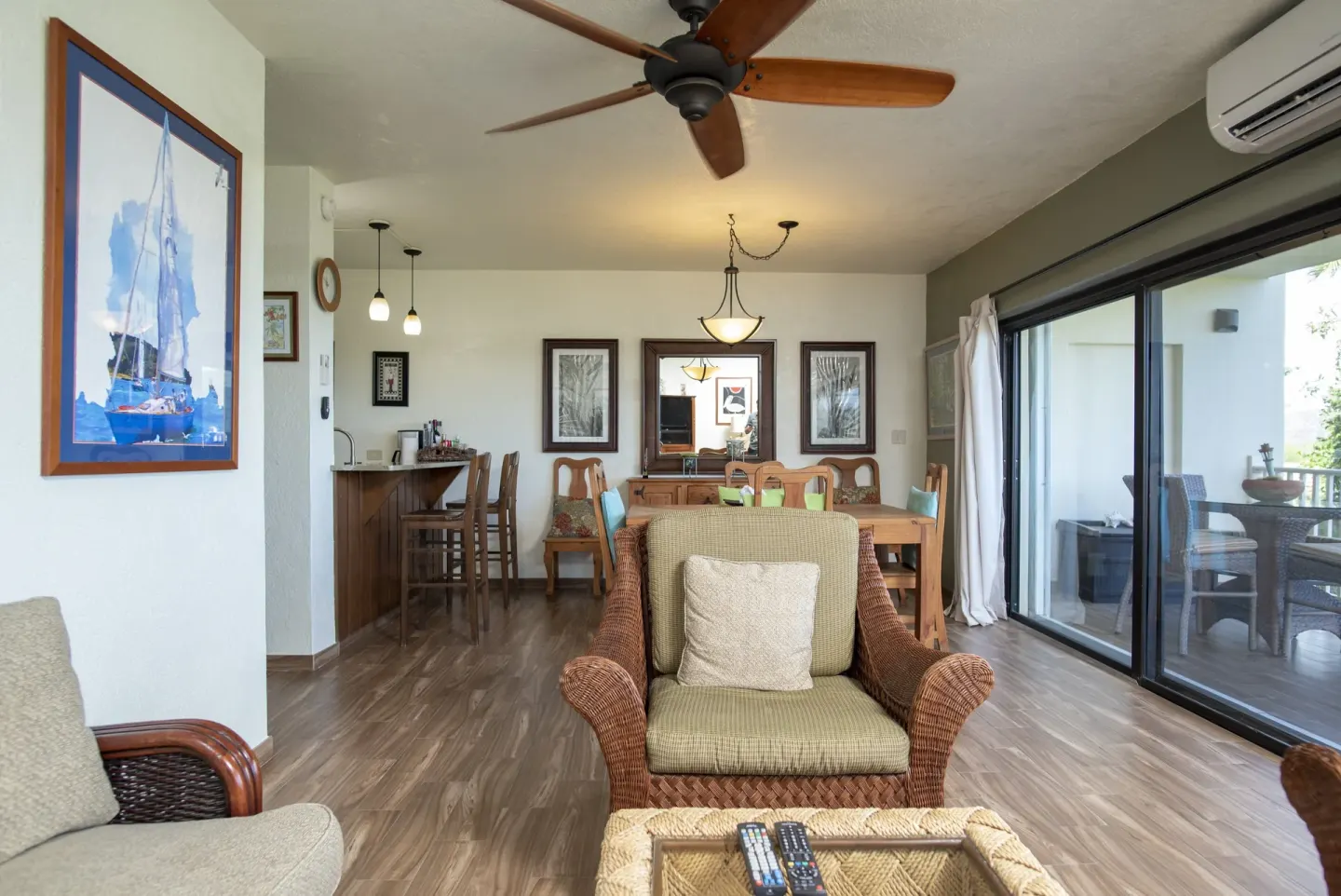 Open condo living and dining room with balcony doors at Point Pleasant Resort.
