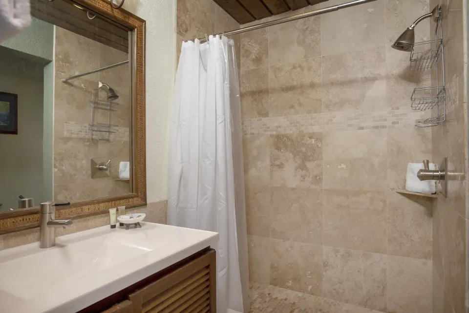 One-bedroom condo bathroom with tiled shower and vanity at Point Pleasant Resort.