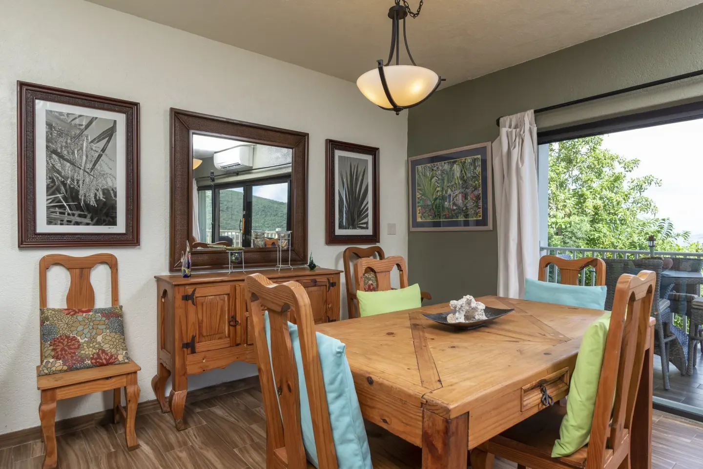One-bedroom condo dining area with wood table and balcony doors at Point Pleasant Resort.
