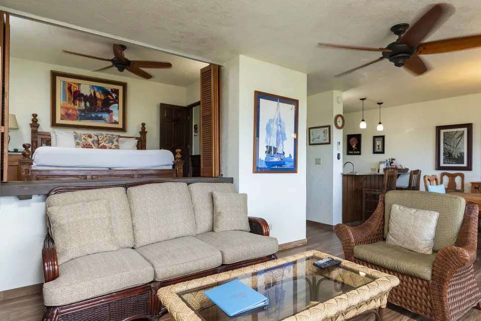 One-bedroom condo living area with raised bed and kitchenette at Point Pleasant Resort.