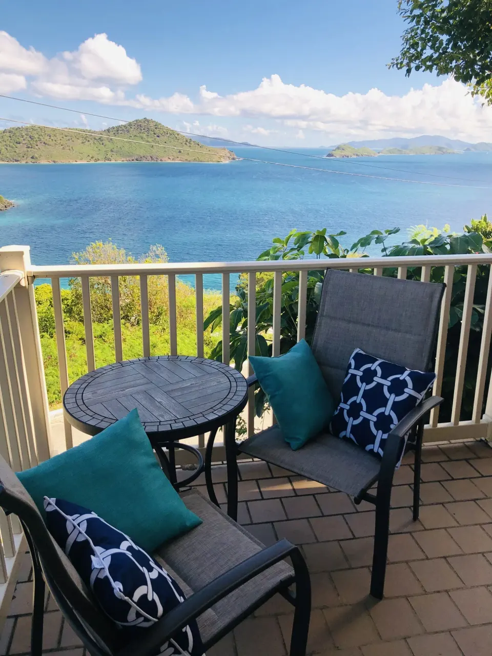 Studio balcony seating with round table and ocean view at Point Pleasant Resort.