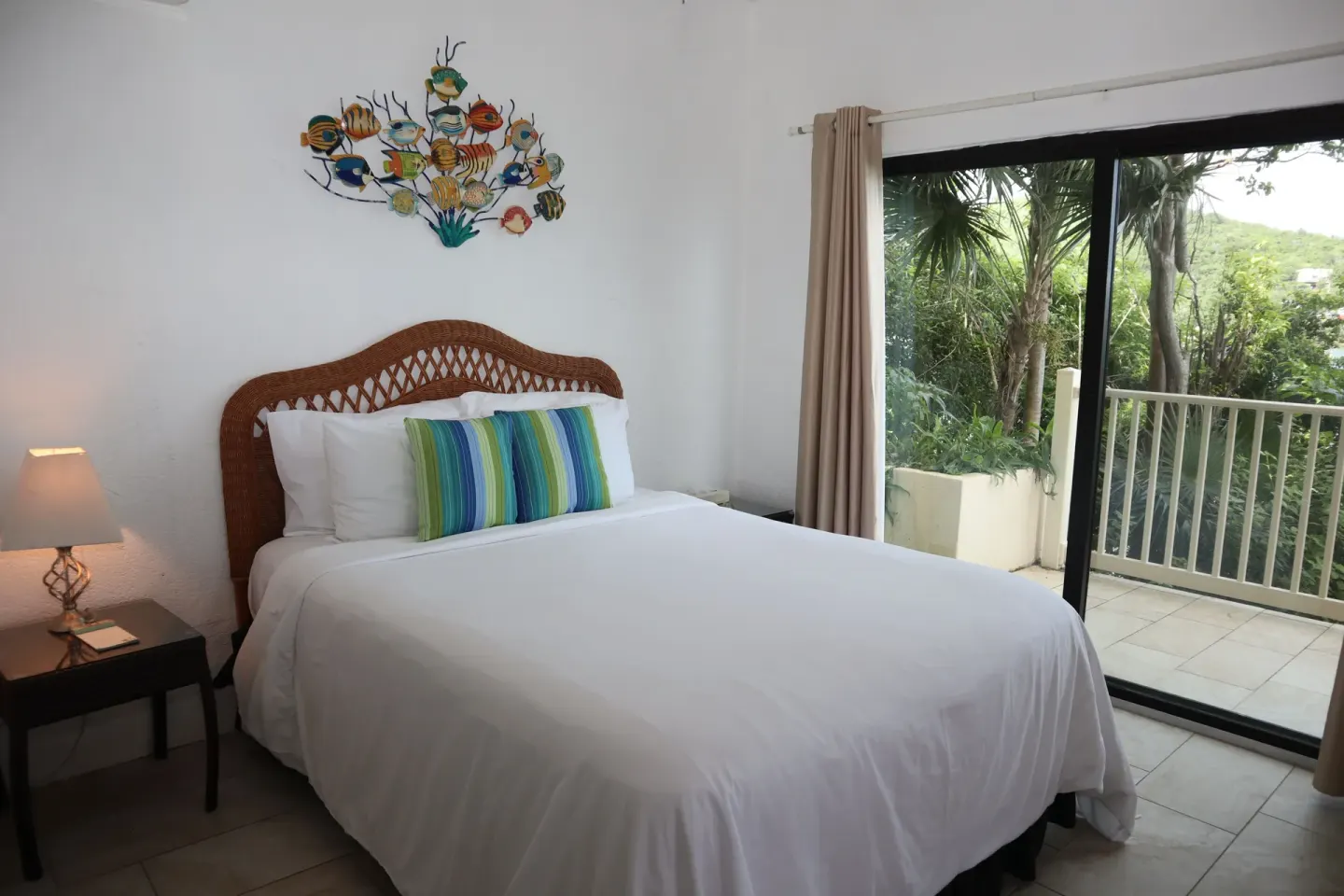 Studio bed beside sliding glass doors to a balcony at Point Pleasant Resort.