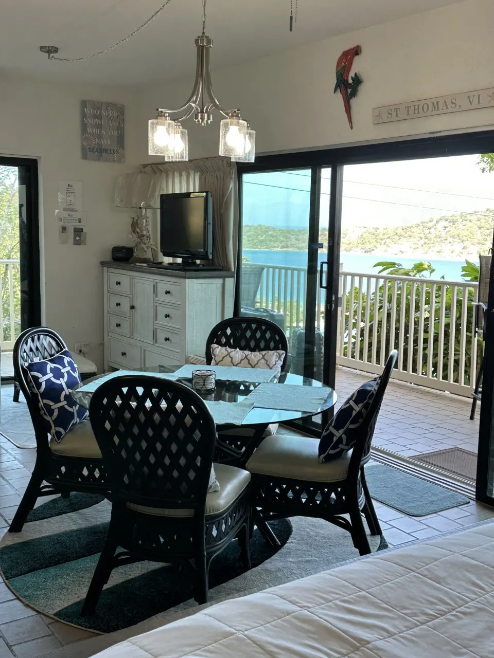 Studio room dining area, bed edge, and balcony view at Point Pleasant Resort.