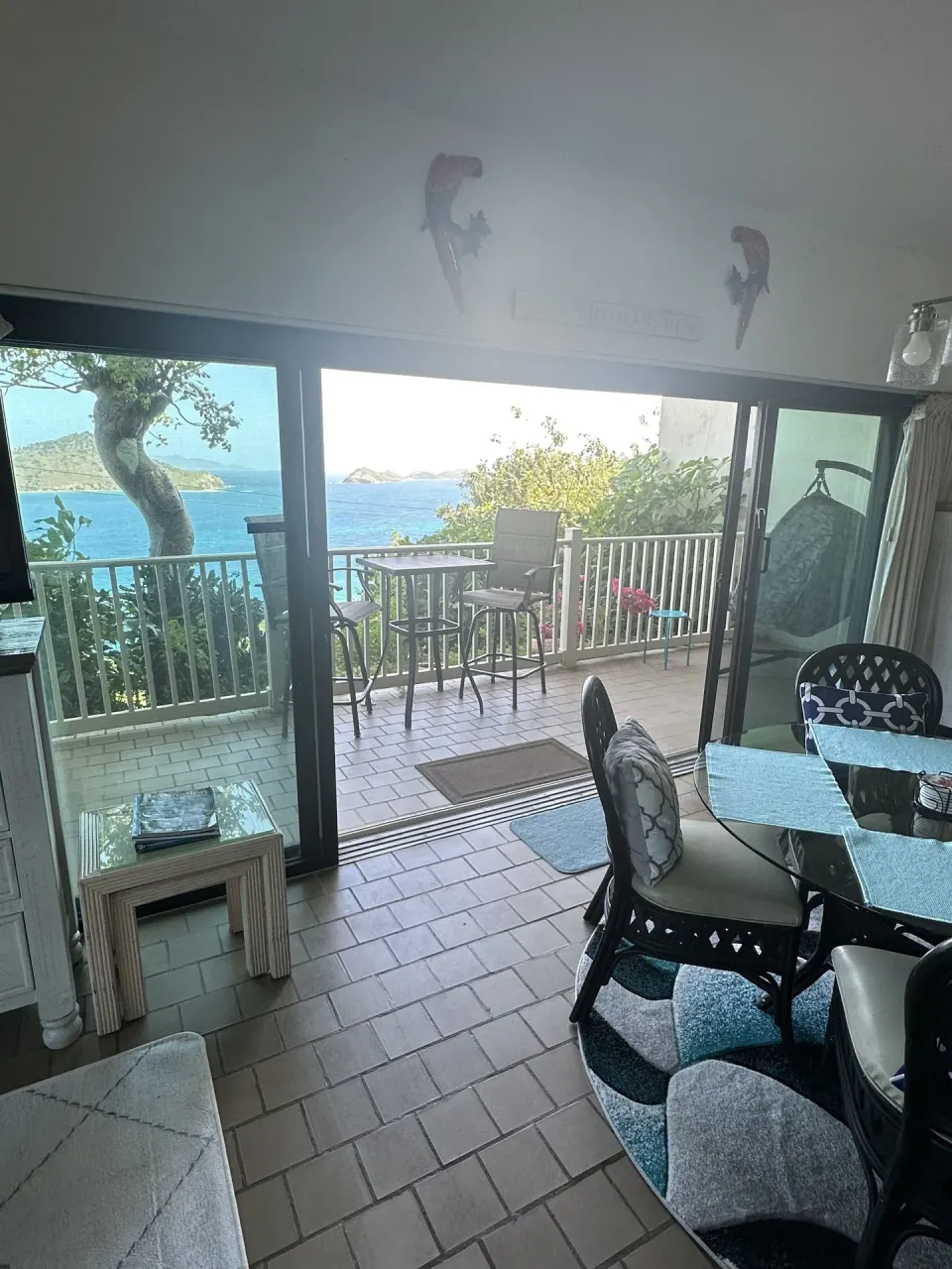 Studio room with dining table and open balcony facing the water at Point Pleasant Resort.