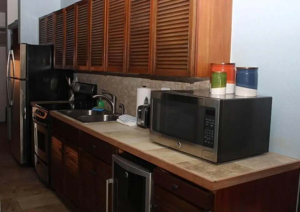 Studio kitchen with appliances and wood cabinets at Point Pleasant Resort.