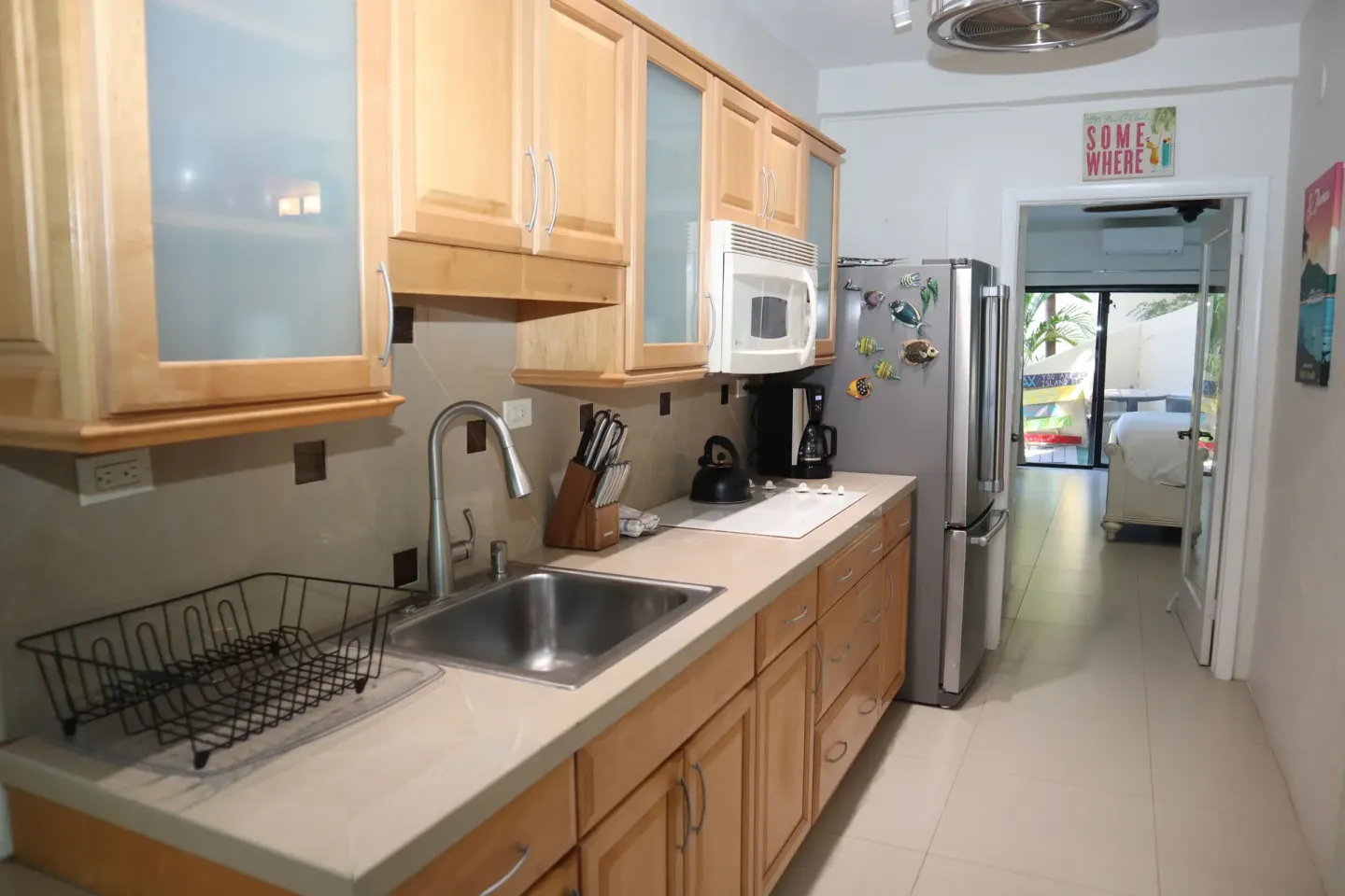 Studio kitchen with wood cabinets and view toward the bedroom at Point Pleasant Resort.