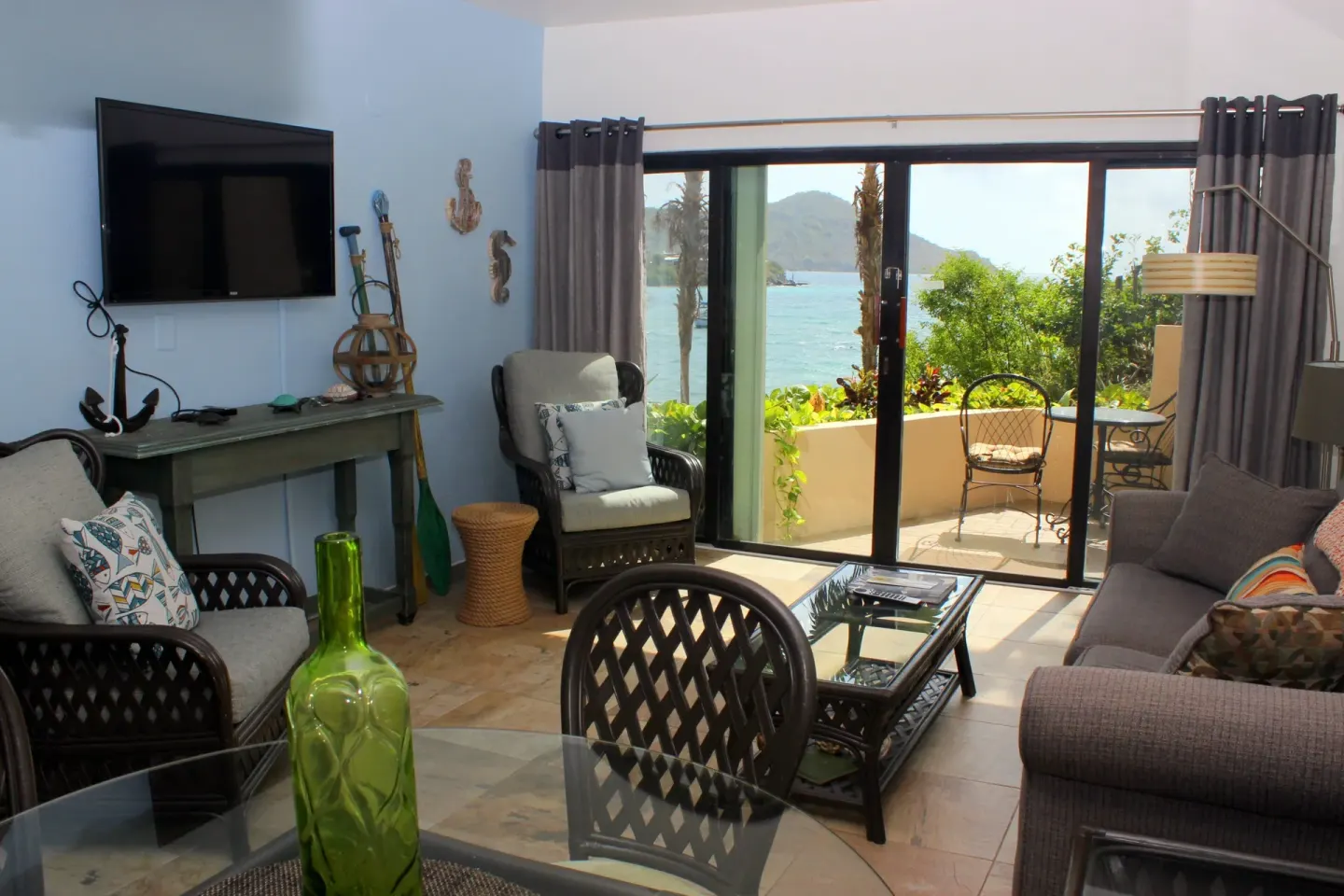 Studio living area with seating and balcony water view at Point Pleasant Resort.