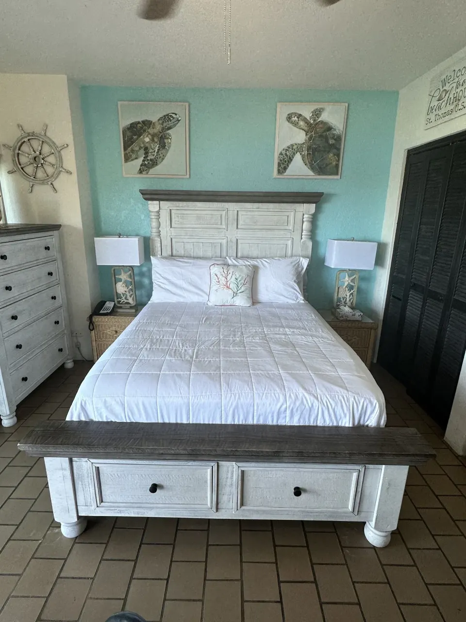 Studio bedroom with a bed, dresser, and dark closet doors at Point Pleasant Resort.