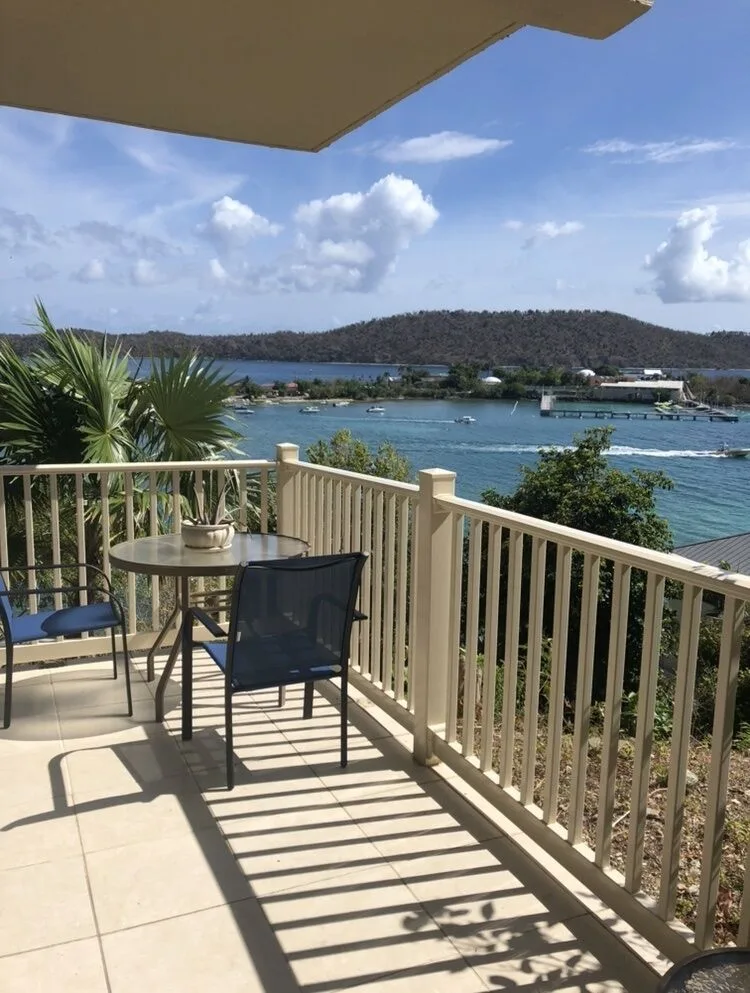 Studio balcony with table, chairs, railing, and bay view at Point Pleasant Resort.