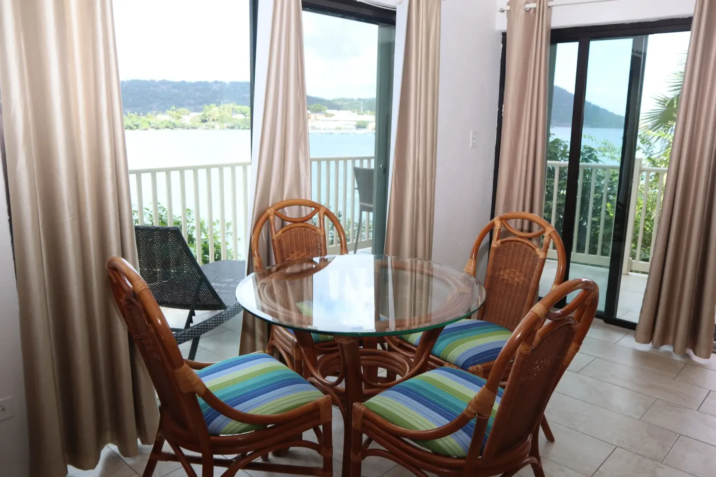 Studio dining table beside balcony doors with water views at Point Pleasant Resort.