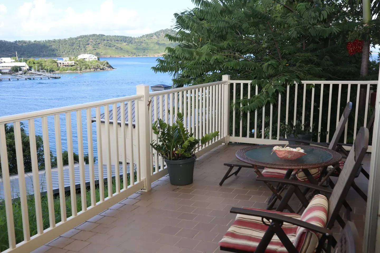 Studio terrace with cushioned chairs and bay view at Point Pleasant Resort.