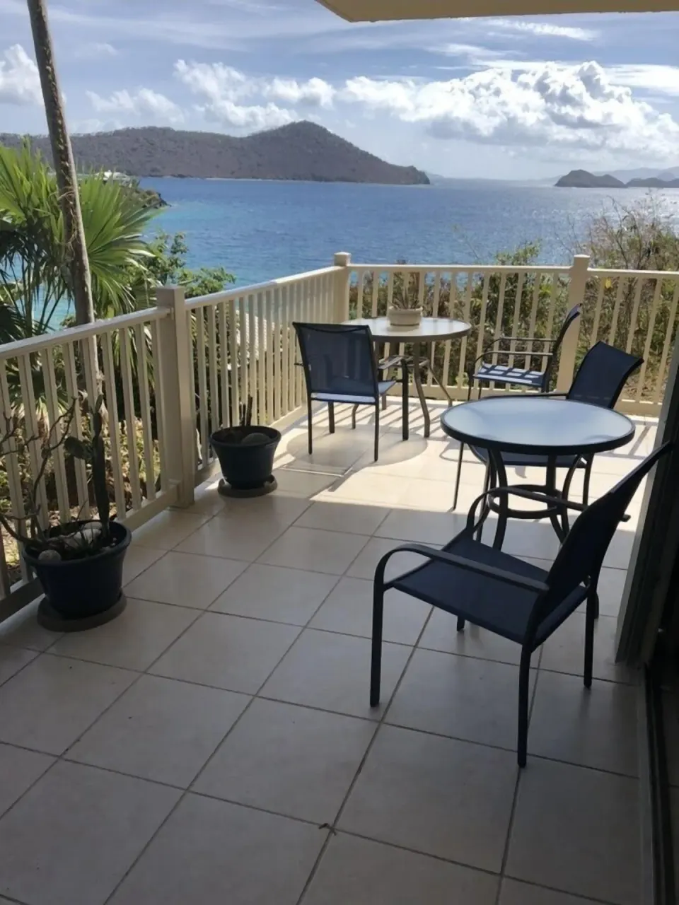 Studio terrace with tables, chairs, and ocean view at Point Pleasant Resort.
