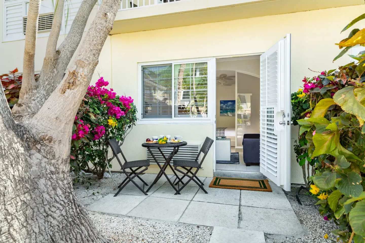 Garden patio with bistro table outside a guest room at Ports of Call Resort.
