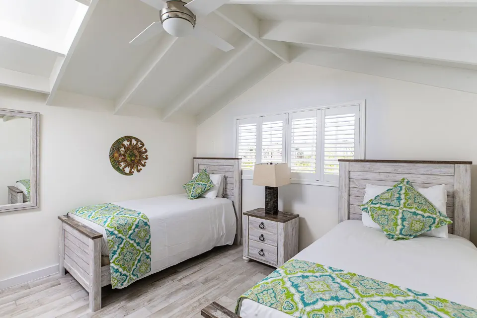 Two twin beds in a bright guest room at Ports of Call Resort.