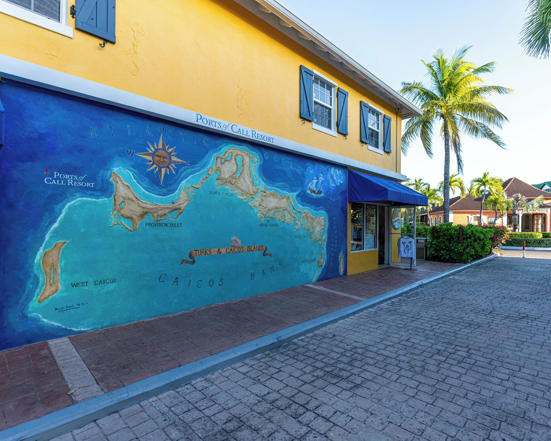 Exterior wall mural and entrance on a yellow building at Ports of Call Resort.