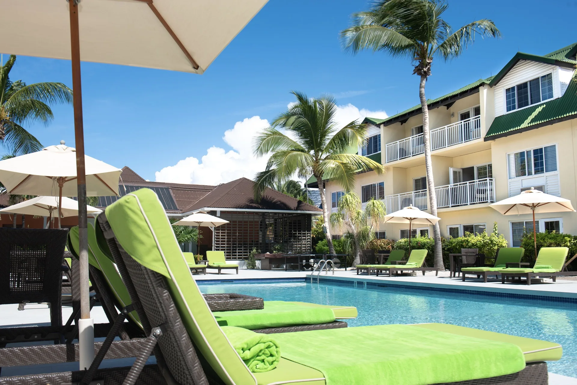 Lime-green lounge chairs beside the pool at Ports of Call Resort.
