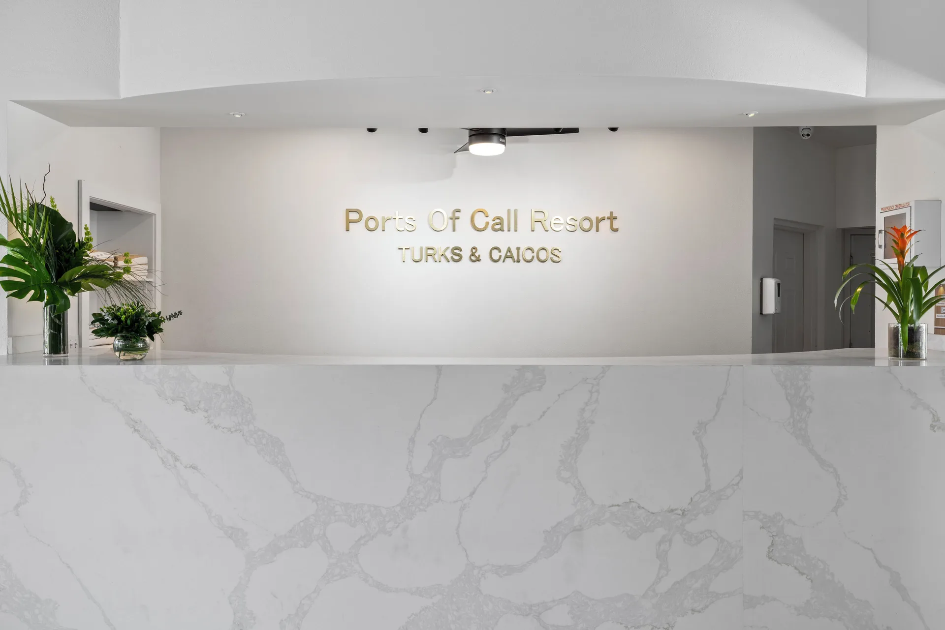 White marble-look reception counter and wall sign at Ports of Call Resort.