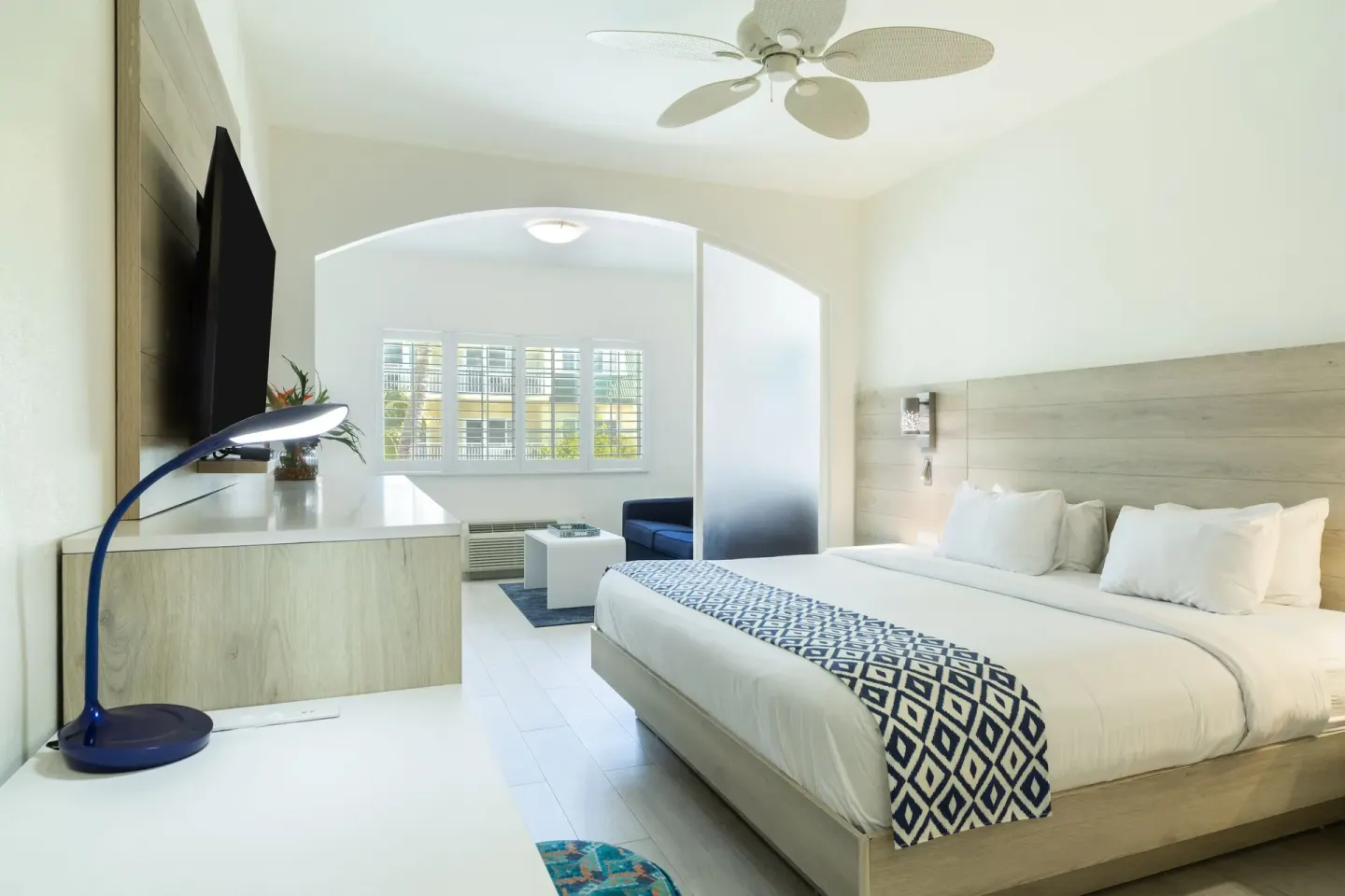 King bed suite with TV console and sitting area at Ports of Call Resort.