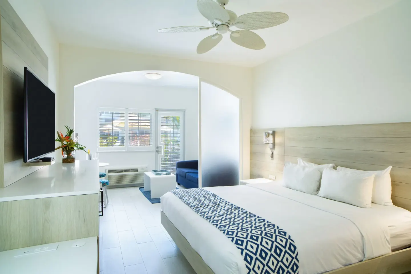 King bed suite with sitting area and TV at Ports of Call Resort.