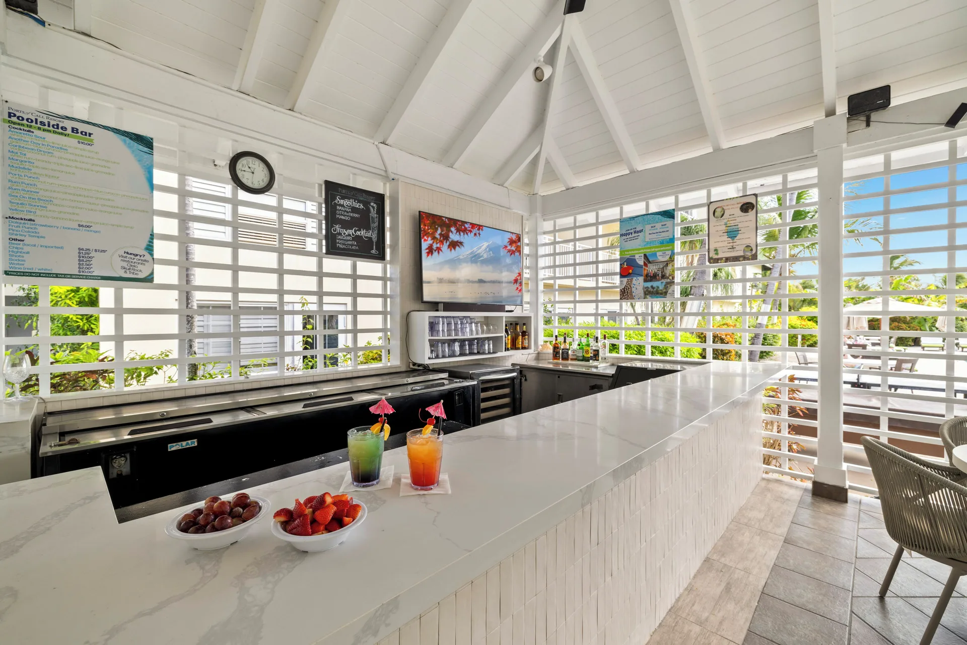 Poolside Bar counter with drinks and fruit inside Ports of Call Resort.