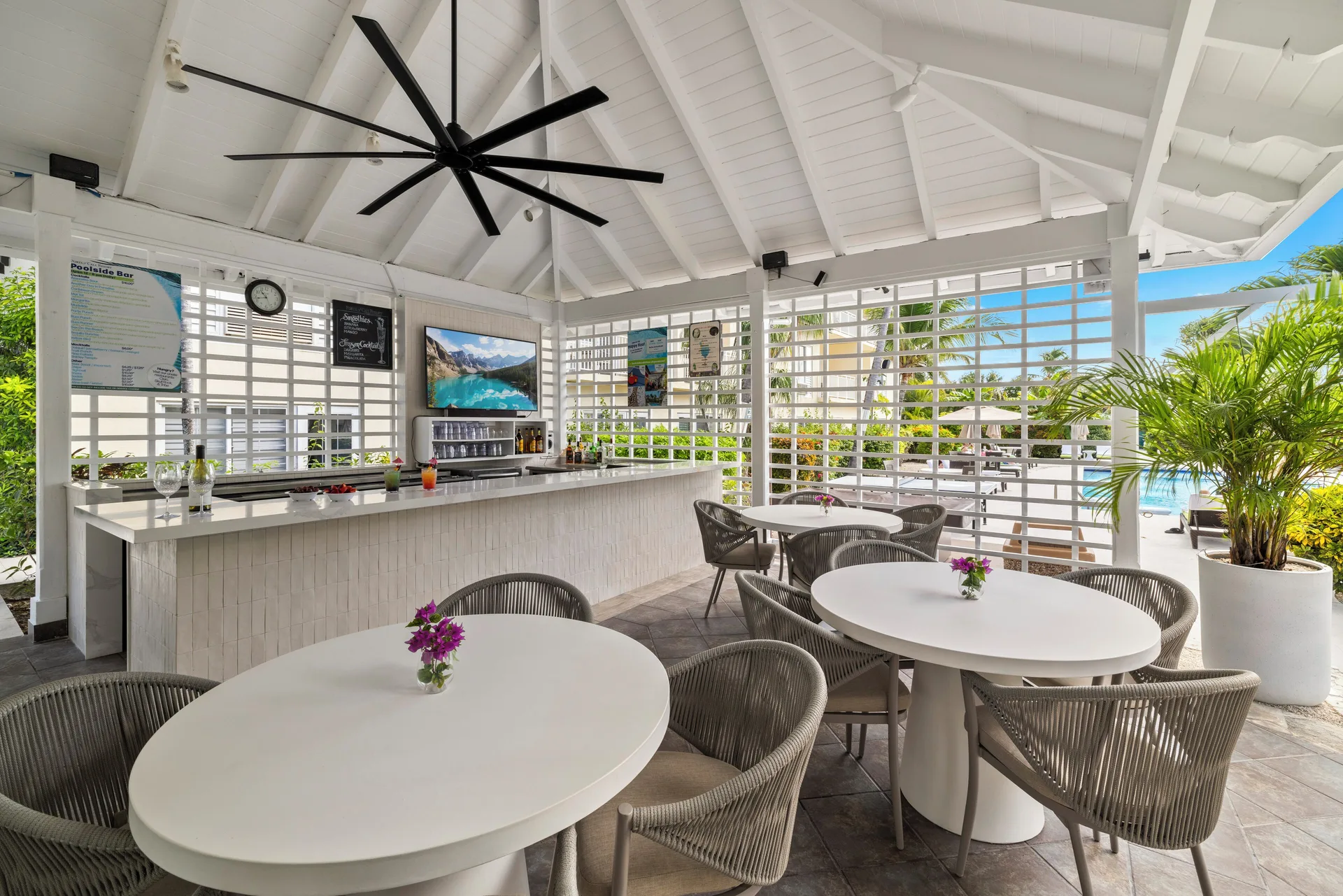 Open-air Poolside Bar seating and counter at Ports of Call Resort.