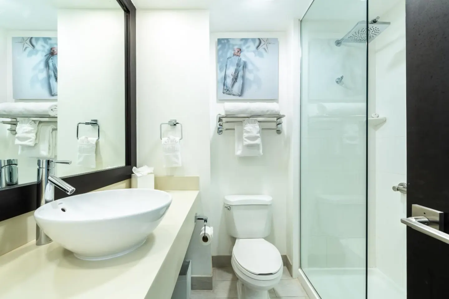 Guest room bathroom with vessel sink and glass shower at Ports of Call Resort.