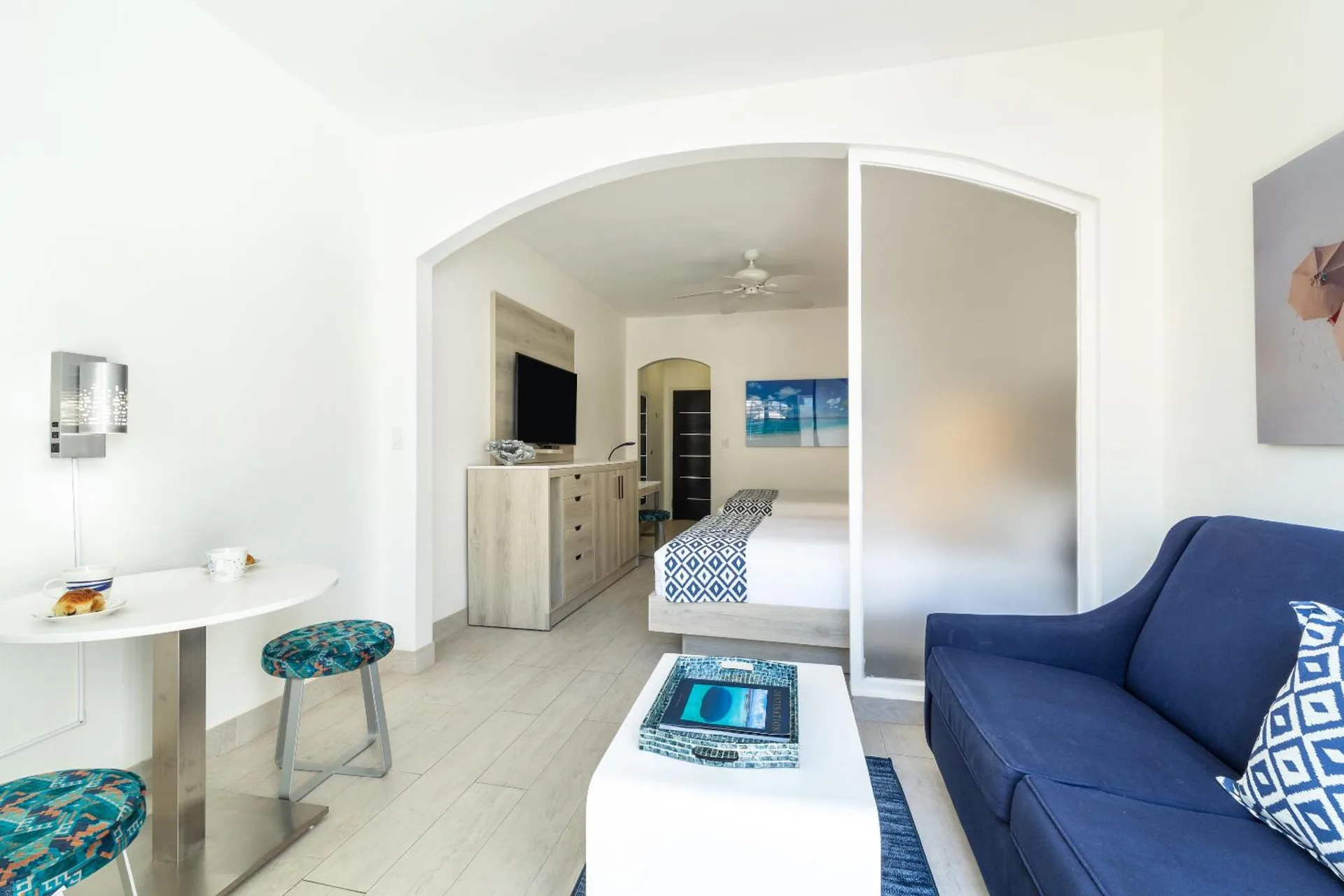 Guest room sitting area with bed beyond at Ports of Call Resort.