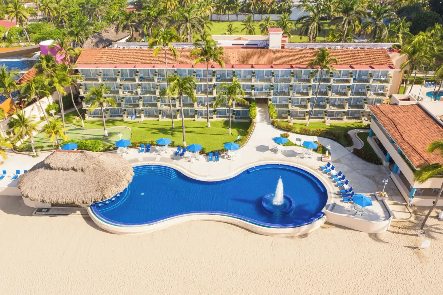 Aerial view of the beachfront pool and guest-room wing at Posada Real Ixtapa.