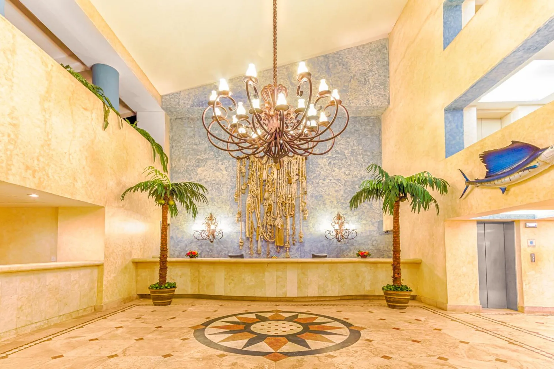Lobby chandelier and reception area at Posada Real Ixtapa.