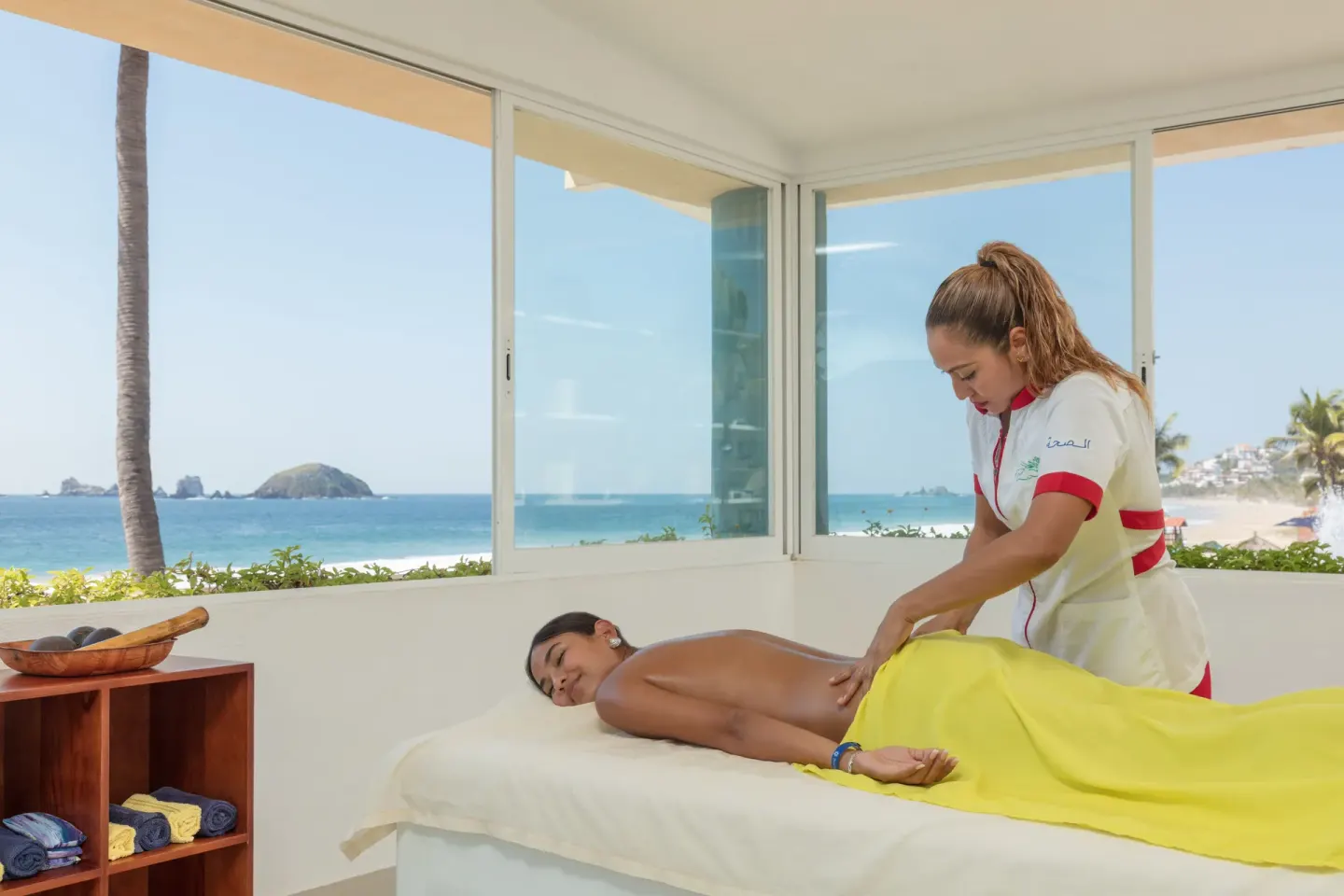 A therapist gives a massage in an ocean-view room at Posada Real Ixtapa.