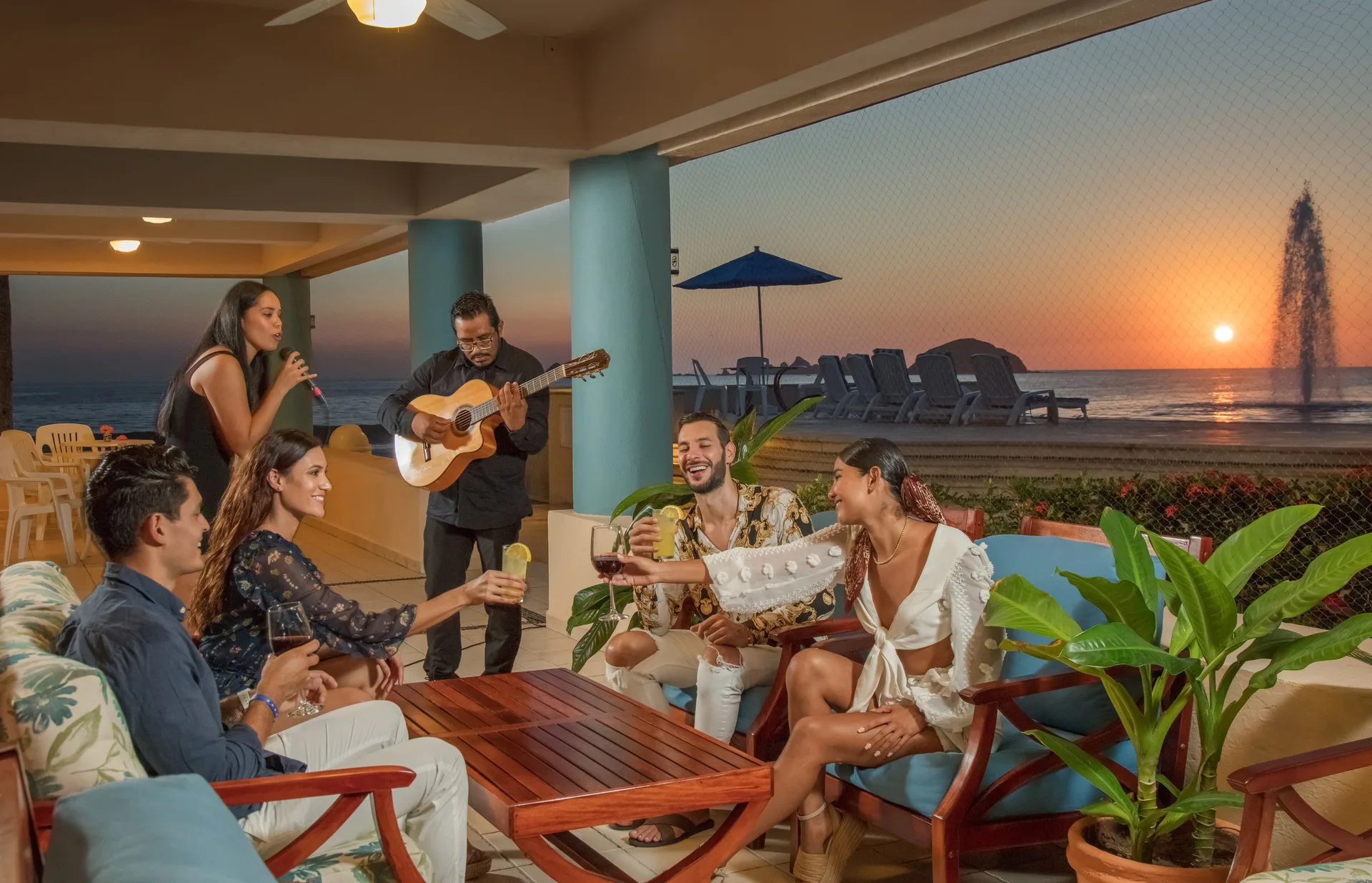 Guests enjoy drinks and live guitar music by the ocean at Posada Real Ixtapa.
